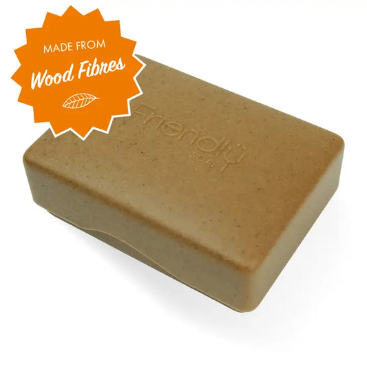 Brown bar of soap with 'friendly' branding and an orange label indicating wood fibres on a white background.
