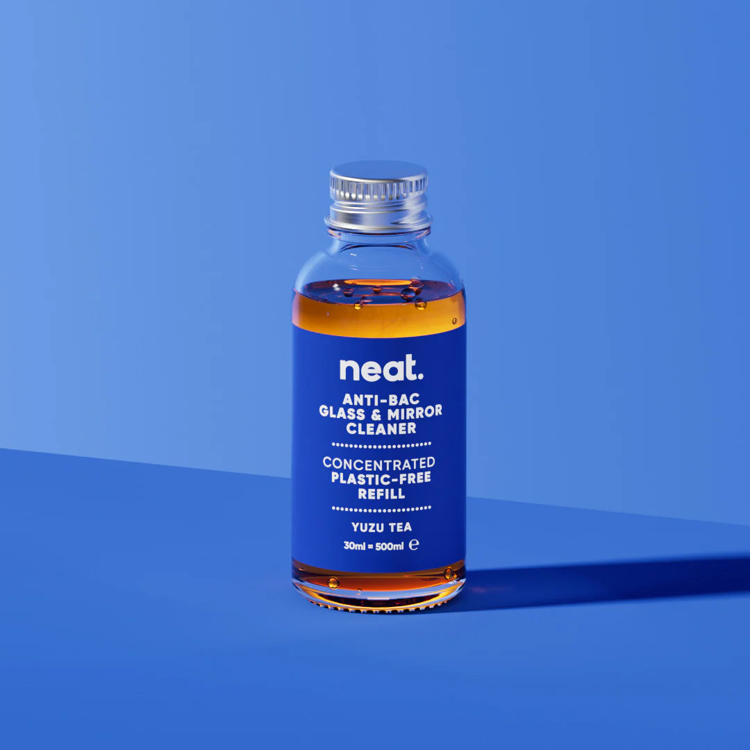 Bottle of neat glass and mirror cleaner on a blue background