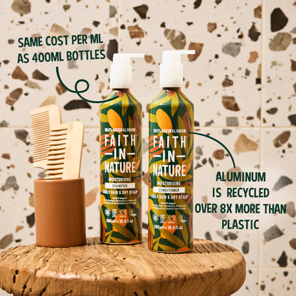 Two bottles of Faith in Nature shampoo and conditioner on a wooden table with a terrazzo patterned wall in the background.