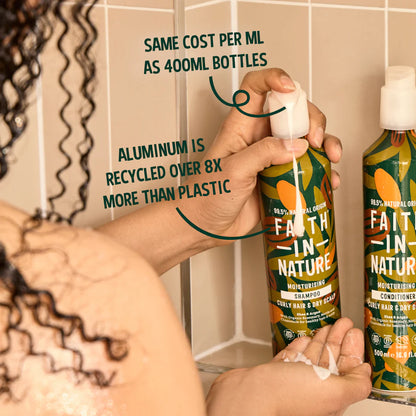 Person holding a bottle of Faith in Nature shampoo with text about sustainability.