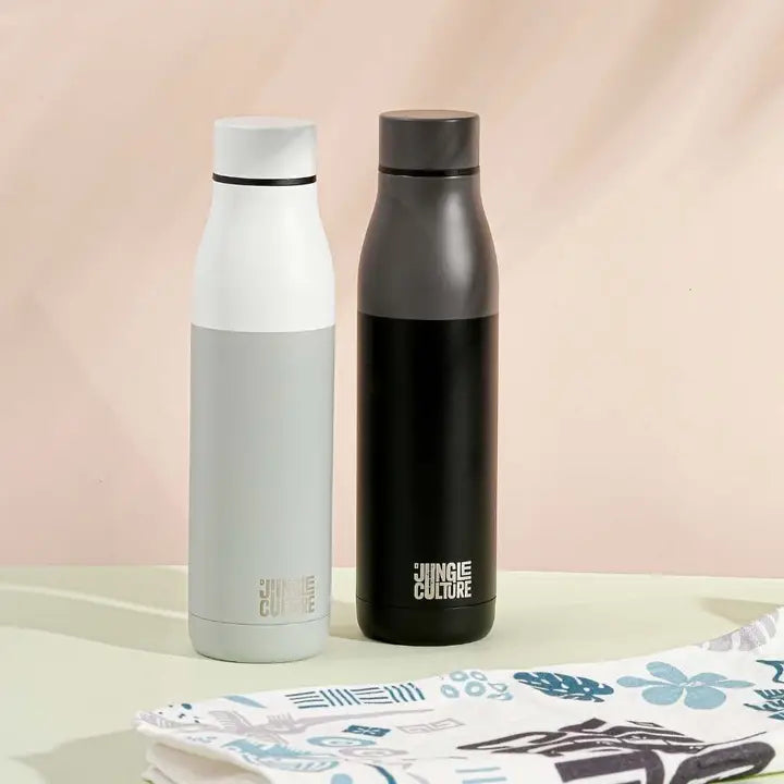 Two insulated water bottles with 'Jungle Culture' branding on a light surface.