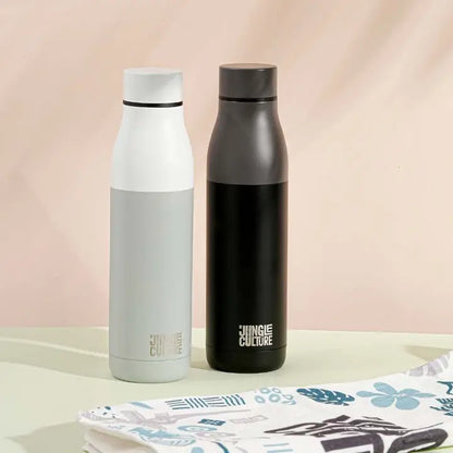 Two insulated water bottles with 'Jungle Culture' branding on a light surface.