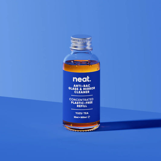 Bottle of neat glass and mirror cleaner on a blue background